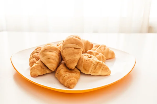 Croissants in a white plate — Stock Photo, Image