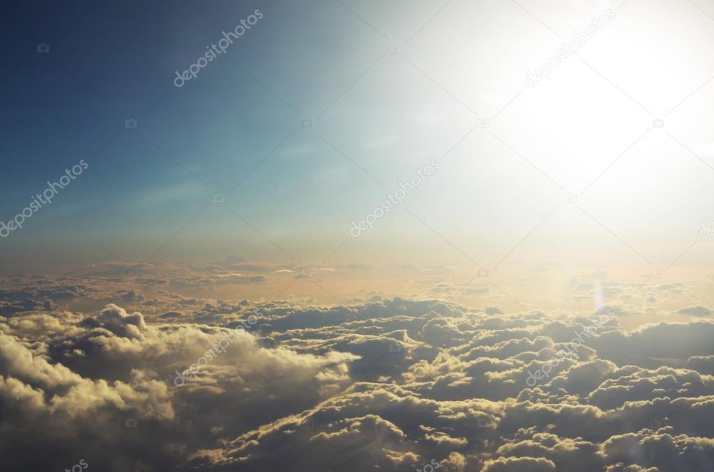 Clouds from the top and dramatic sunset, airplane view