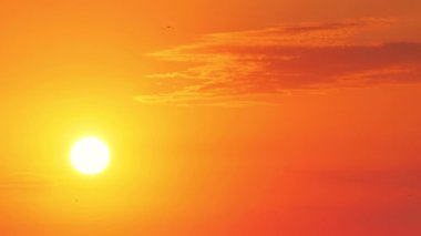 Sun and burning golden sky with clouds. Sunrise, 4k video