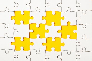 Missing puzzle pieces on yellow background clipart