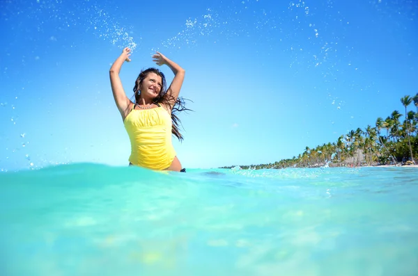 Mulher feliz brincando com água na praia exótica — Fotografia de Stock