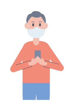 Genç adam akıllı telefon kullanarak yüz maskesi takıyor.