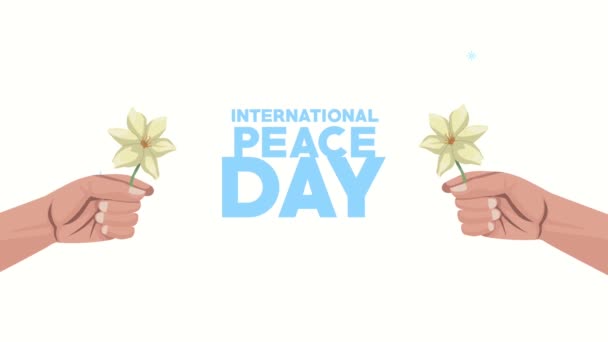 Internationale vredesdag belettering met handen tillen bloemen — Stockvideo