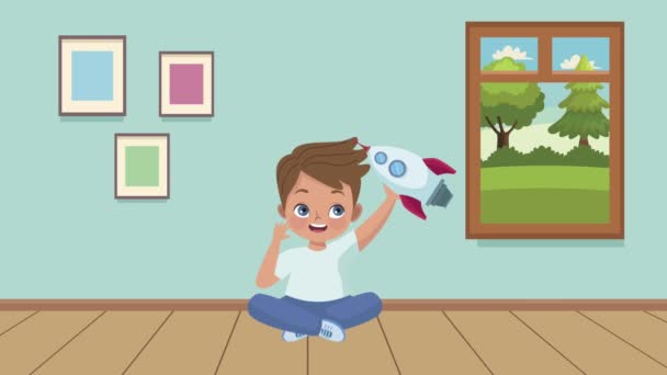 Маленький мальчик играет с ракетой в комнате — стоковое видео