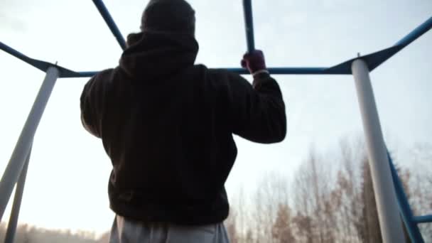 Man pulled on the bar at morning. slow motion — Stock Footage Man pulled on the bar at morning. slow motion Stock Footage