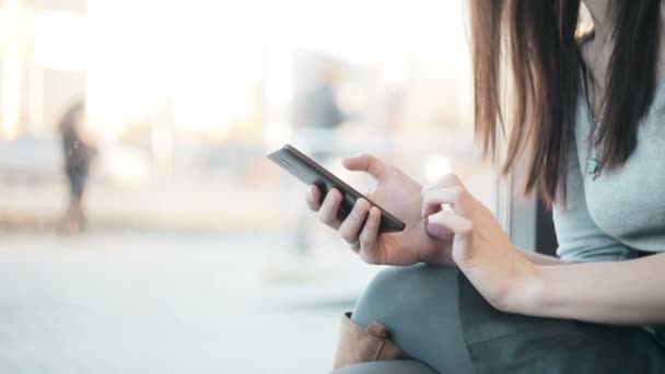 Las manos de la mujer mensajes de texto, utilizando el teléfono inteligente en la cafetería . — Vídeos de Stock