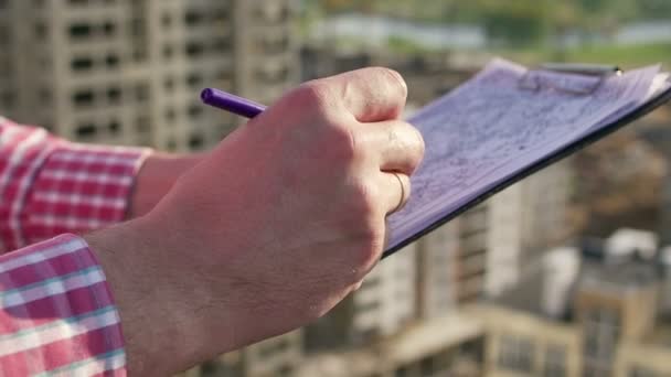 Engineer takes notes on drawings. hands close-up. — Stock Video