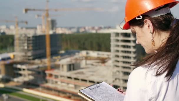 La arquitecta inspecciona el sitio de construcción — Vídeo de stock