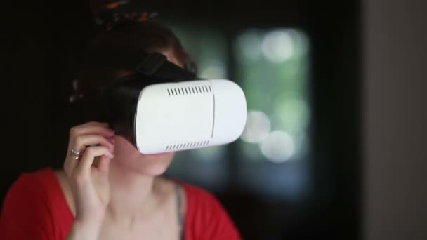 Young woman playing game using VR-helmet — Stock Video