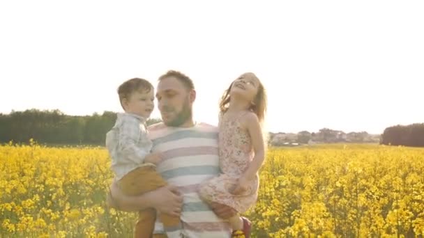 Father holds on hands his son and daughter Slow mo — Stock Video