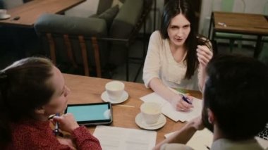 Birlikte kafede çalışan yaratıcı ekip tartışması