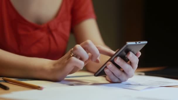 Dames handen controles rekeningen met behulp van een smartphone — Stockvideo