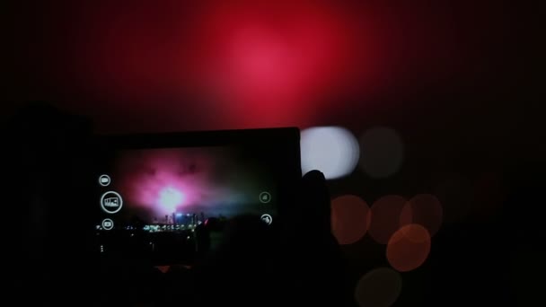 Feux d'artifice filmés par un smartphone la nuit. célébration dans la ville — Video