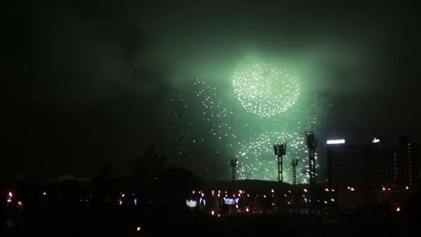 Beautiful fireworks over a football stadium and a street in the city at night. — Stock Video