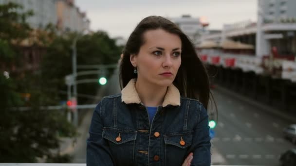 Annoyed girl standing on bridge expresses her dissatisfaction, frustration negative emotions and looks at the camera. 4K — Stock Video