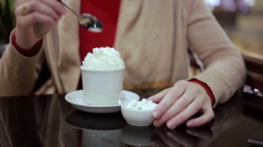 woman adds marshmallows in your coffee with cream