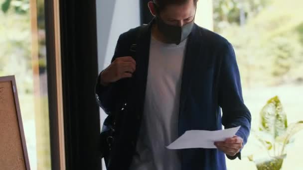 Tracking shot of young serious business wearing safety face mask enter modern office table meeting, sitting down. — Stok Video