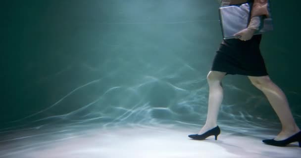 Long way to career success. Cinematic view, young business woman with laptop struggles to walk under water slow motion. — Stock Video