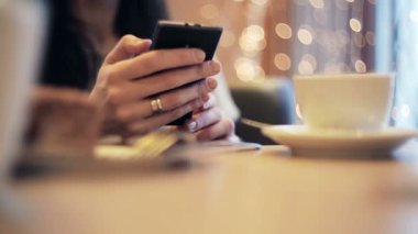 Kadın el manifatura, kafede Smartphone kullanarak.