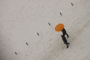 İki parlak şemsiyesi altında kar ötesinde