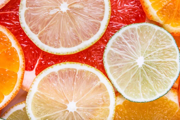 Sliced citrus: oranges, mandarines, lemons, limes, sweetie, grapefruits, witch's broom close-up macro Royalty Free Stock Photos