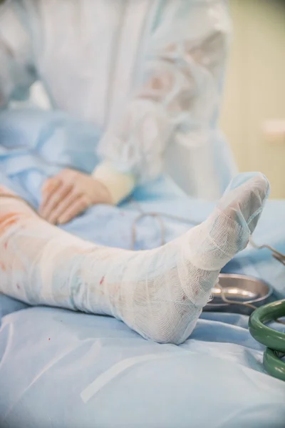 closeup of a foot with the bandage of the patient to surgery on the neck of the femur in the operating room in a hospital