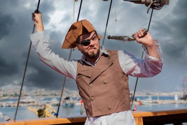 Korsan gemisinde korsan kostümü giymiş bir adamın portresi.