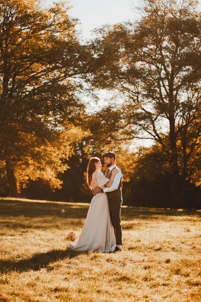 Appena sposati sposo coppia e sposa abbracciando durante l'alba nella natura — Foto Stock