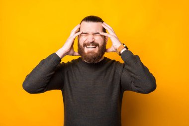 Photo of man touching head, frustrated emotions