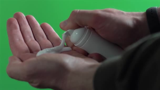 Footage of male washing hands with foam soap over green background — Stock Video