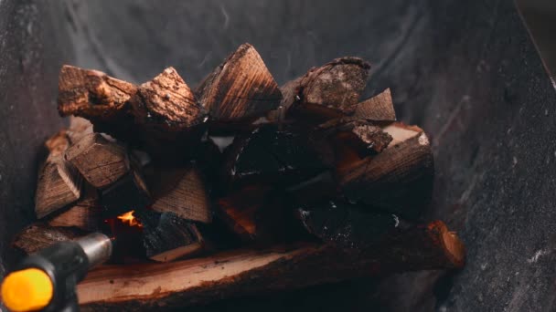 Закрыть кадры, на которых мужчина зажигает огонь для барбекю — стоковое видео