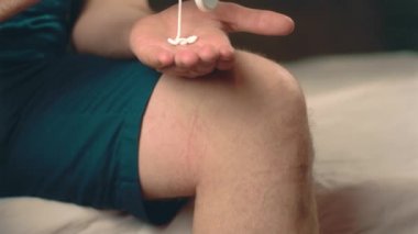 Adamın dizine krem sürdüğü görüntüleri kapatın.