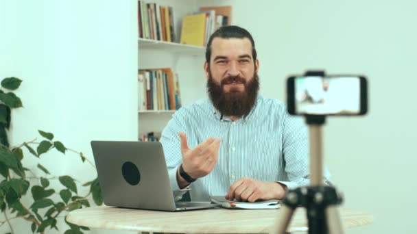 Footage of bearded man sitting in office streaming online video conference — Stock Video