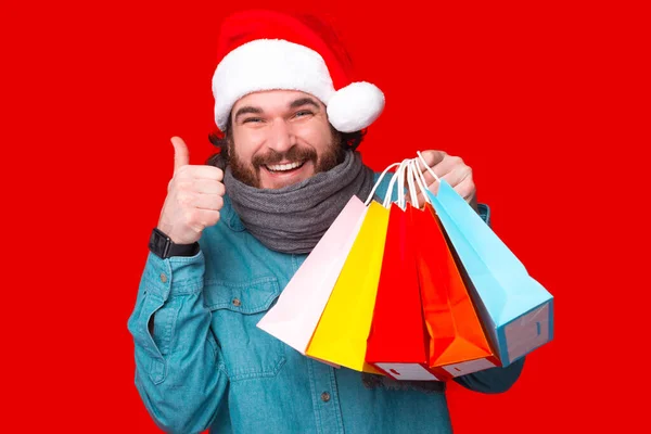 Happy Young Bearded Man Wearing Santa Claus Hat Showing Thumb — Stock Photo, Image