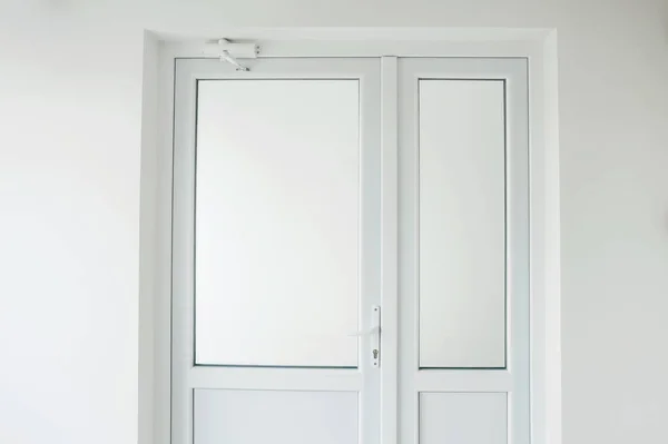 Photo of new white plastic door in office with diffused glass.