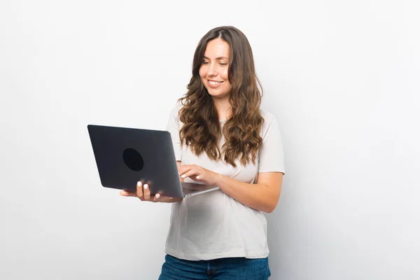 Female student enjoys using her new laptop for work or study. Stock Picture