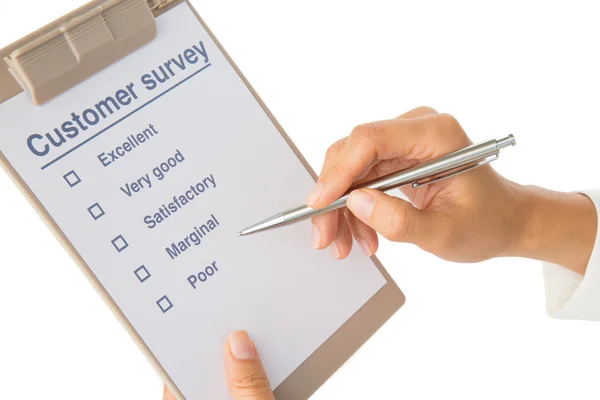 Hand fills out customer survey — Stock Photo, Image