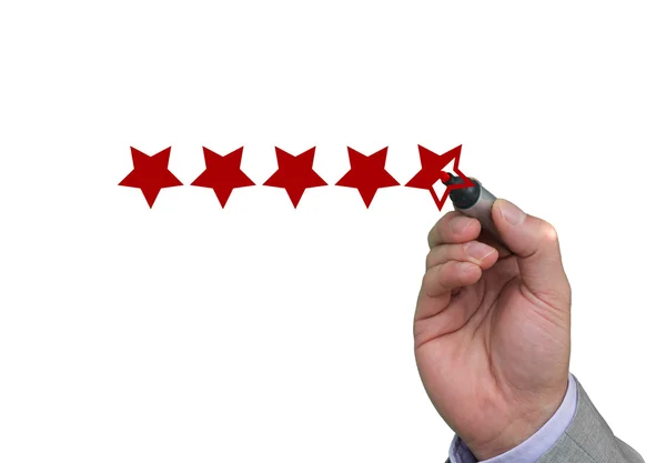 Hand filling out fifth star of performance rating — Stock Photo, Image