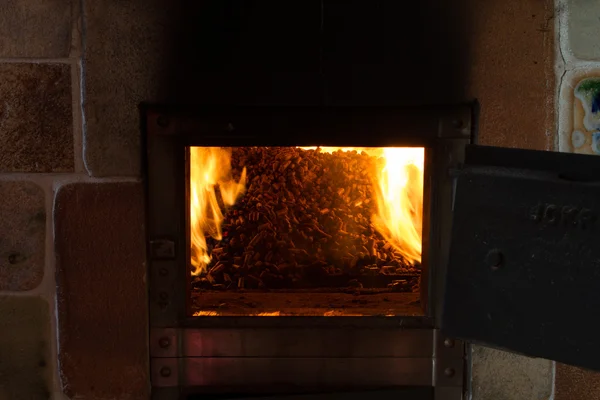 Burning in the furnace pellets from pine — Stock Photo, Image