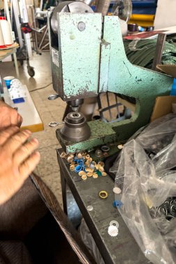 Ağır tekstil malzemelerinin üzerine göz merceği yerleştirmek için elle işletilen basının kapatılması