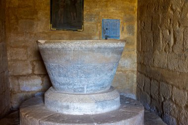 Zorita del Paramo 'daki San Lorenzo kilisesinin iç kısımlarında bulunan karmaşık geometrik ve birbirine karışmış motiflere sahip büyük konik taş vaftiz yazı tipi..