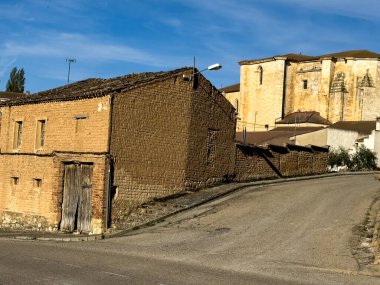 Castrillo de Don Juan 'daki tarihi kiliseye giden dar bir yoldaki eski kerpiç evleri.