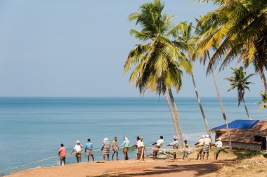 Fishermen pulling a large fishing net