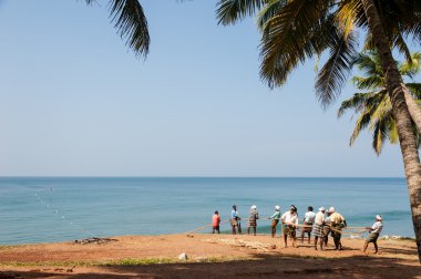 Fishermen pulling a large fishing net