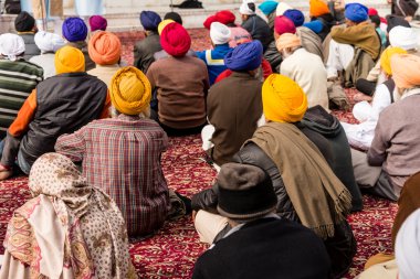Sikh pilgrims sitting at prayer