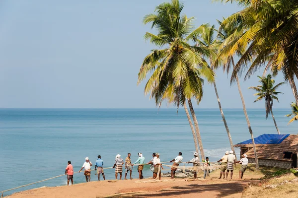 Fishermen pulling a large fishing net