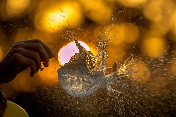 Su balonu patlama günbatımı bir arka plan.