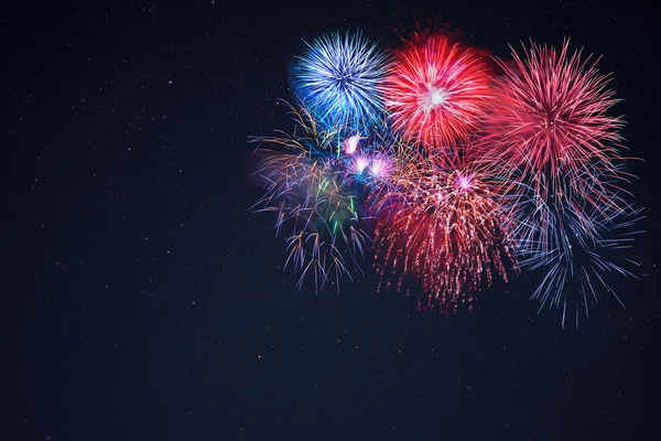 Beautiful celebration fireworks over starry sky, copy space