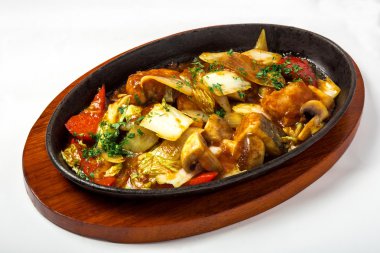 Stewed vegetables with meat in gravy and decorated fresh herbs