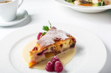 Piece of delicious clafoutis with nectarine and plum